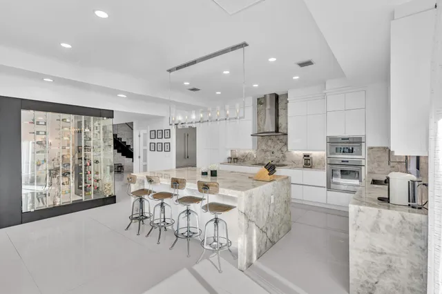 a bedroom with a large bed and a flat tv screen on a dresser