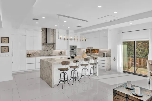 a bathroom with a sink a toilet a light fixture and mirror