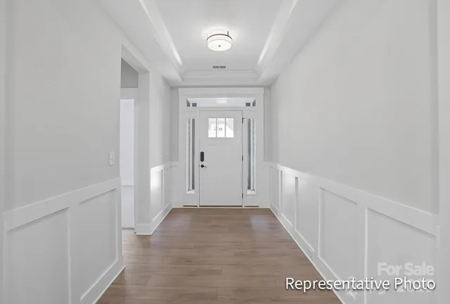 a view of hallway with wooden floor