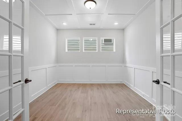 a view of a room with wooden floors and white walls