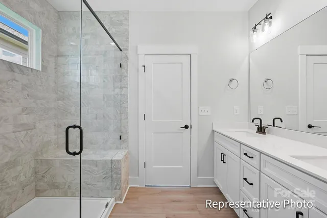 a bathroom with a shower sink and mirror