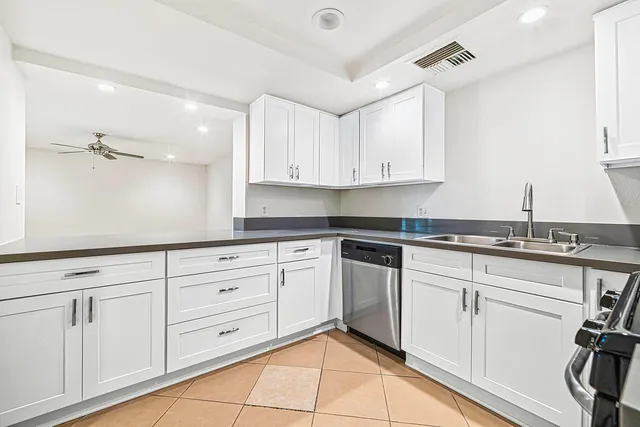 a kitchen with cabinets appliances and a sink