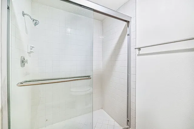 an empty room with a ceiling fan and carpet