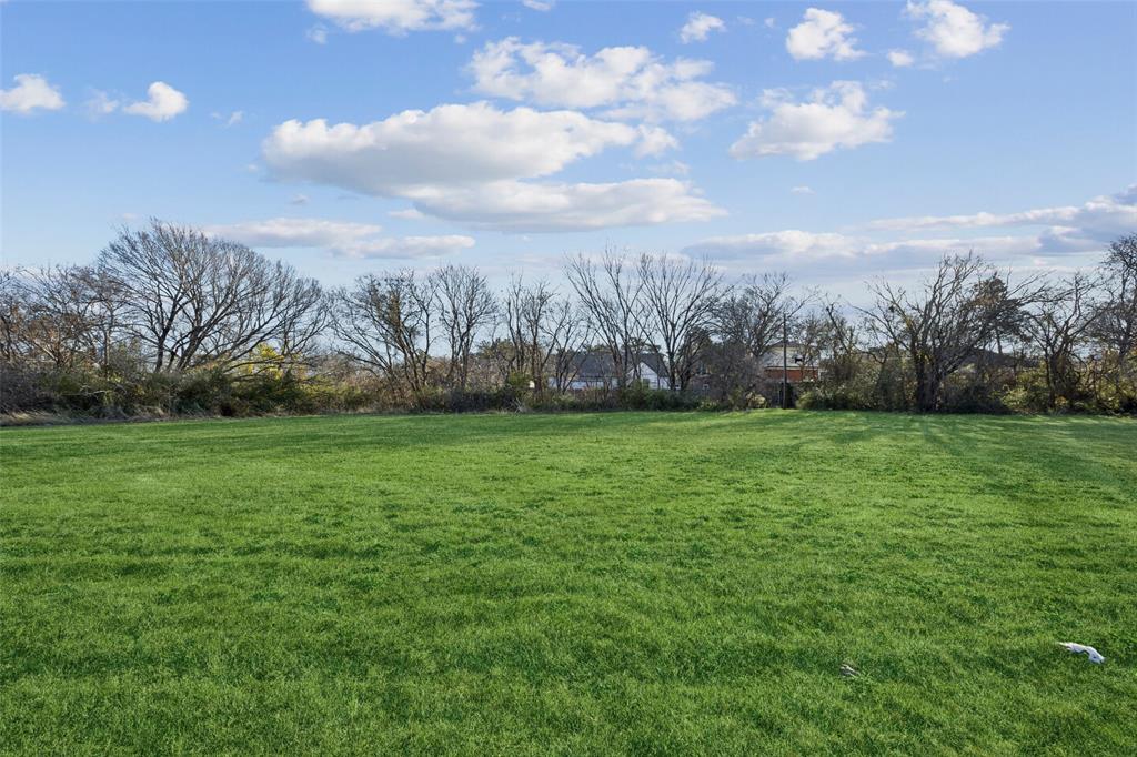 1010 North Cedar Ridge Drive Duncanville, TX 75116 - Photo 2 of 6 a view of outdoor space with green field and trees