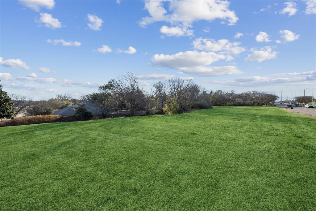 1010 North Cedar Ridge Drive Duncanville, TX 75116 - Photo 6 of 6 a view of a grassy field with trees in the background