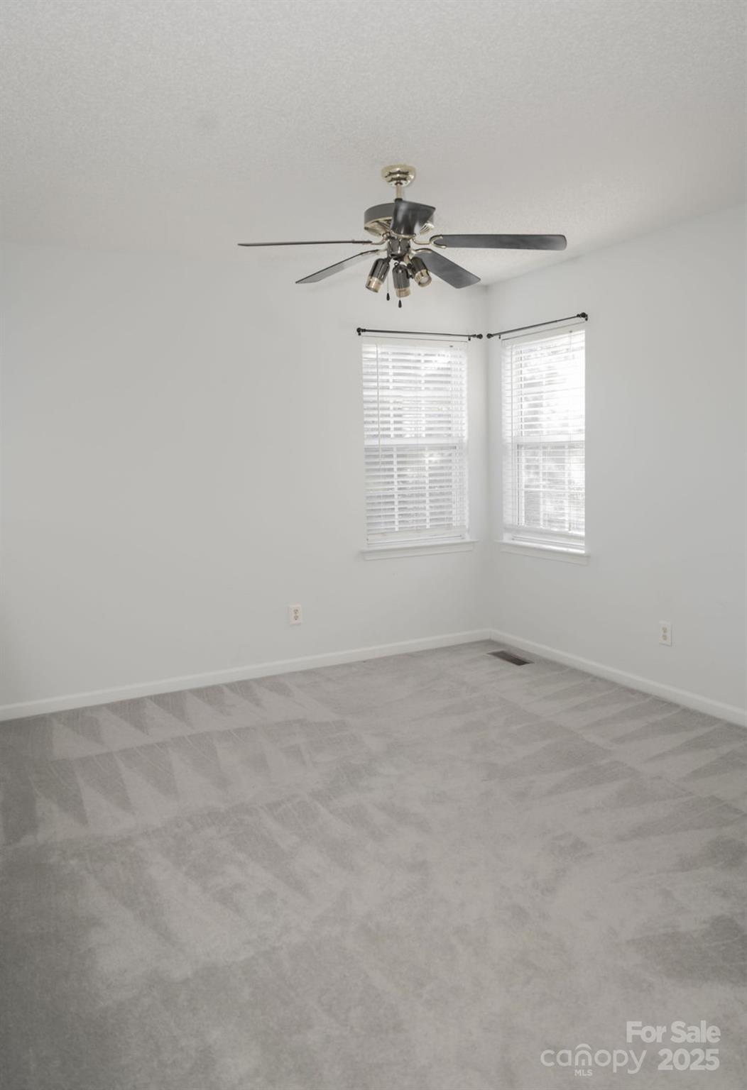 105 South Tanninger Road Mount Holly, NC 28120 - Photo 18 of 46 an empty room with windows and fan