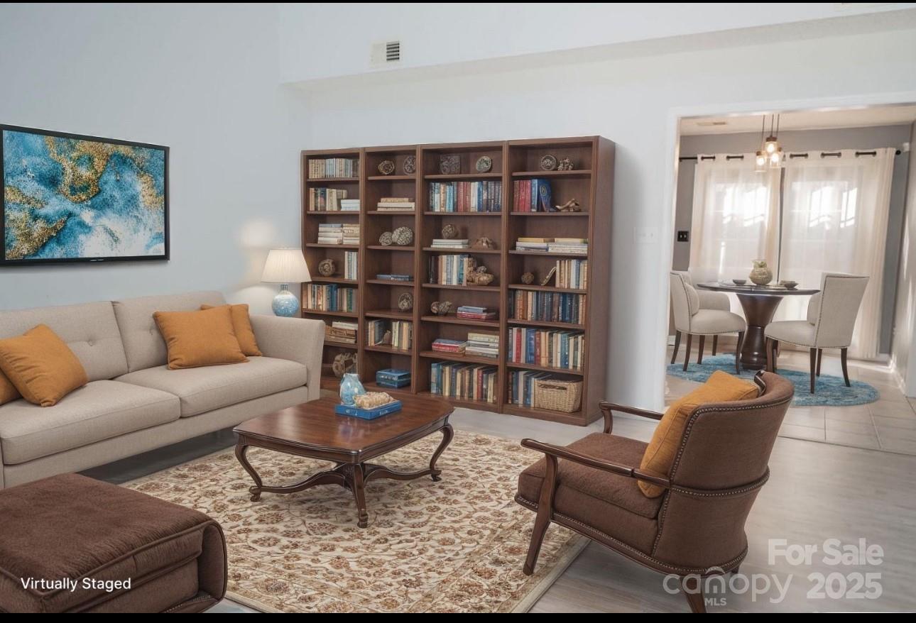 105 South Tanninger Road Mount Holly, NC 28120 - Photo 38 of 46 a living room with furniture a rug and a bookshelf
