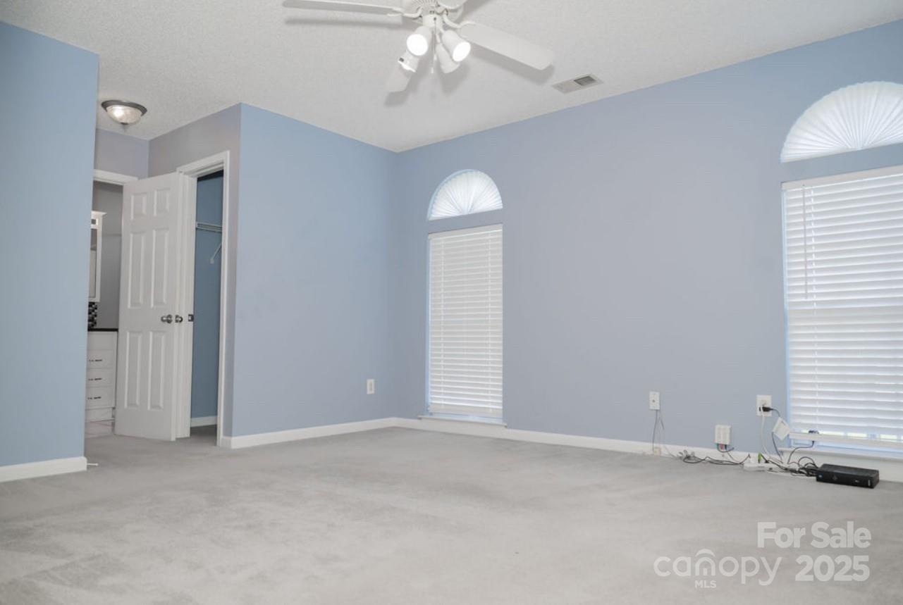 105 South Tanninger Road Mount Holly, NC 28120 - Photo 8 of 46 an empty room with a window and chandelier fan
