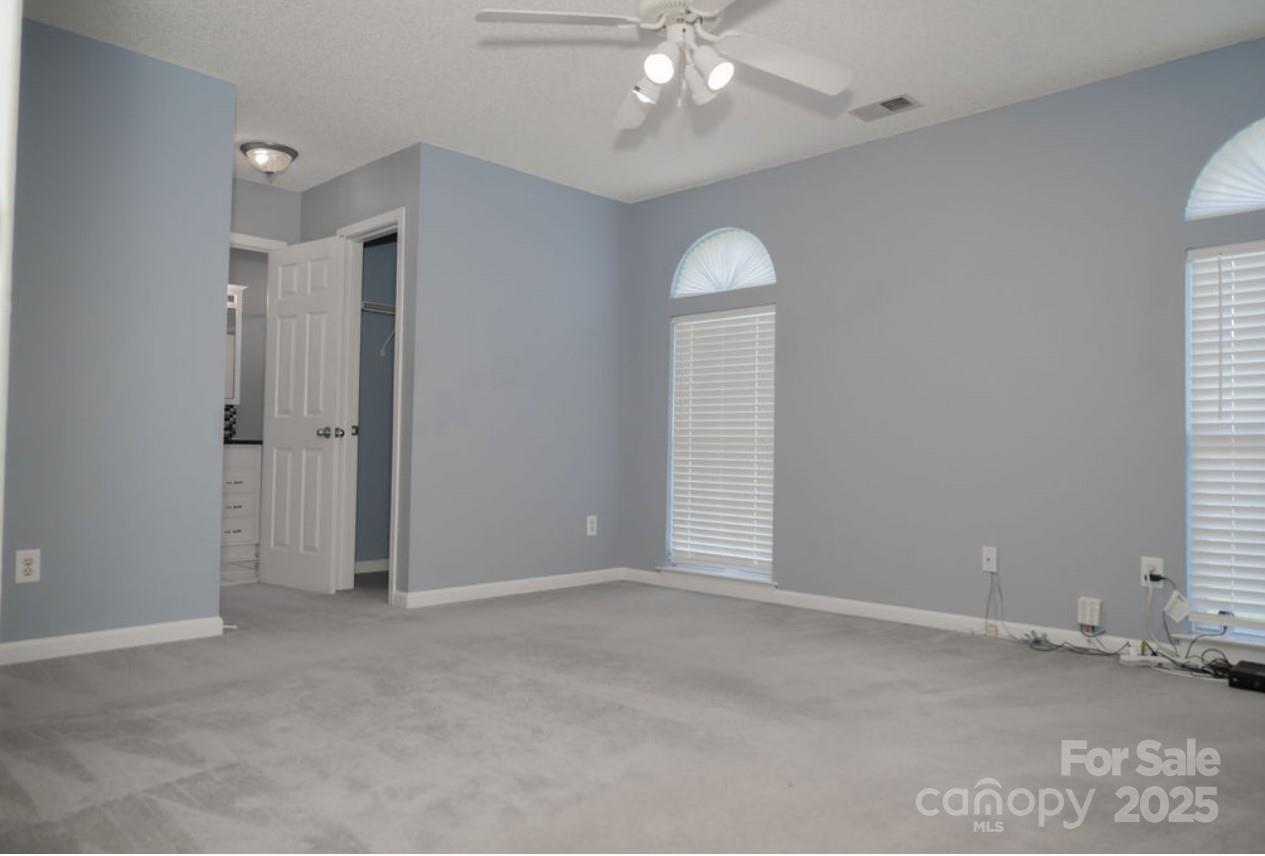 105 South Tanninger Road Mount Holly, NC 28120 - Photo 9 of 46 an empty room with chandelier fan