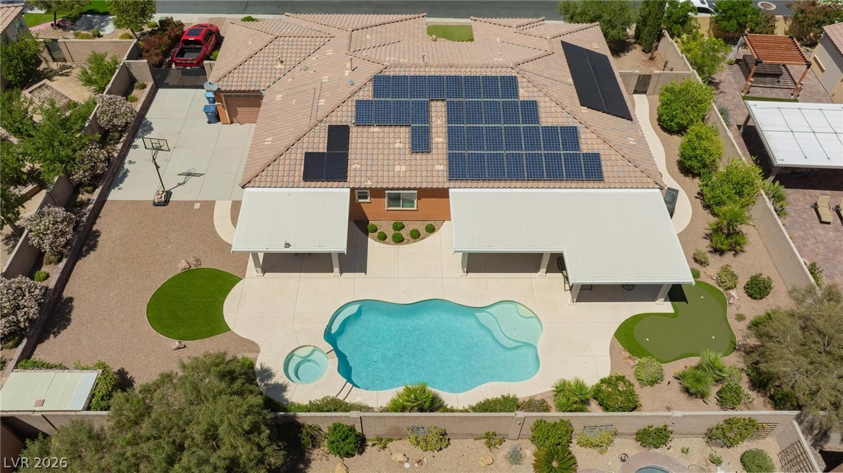 8431 Durango Ranch Court Las Vegas, NV 89113 - Photo 43 of 49 An aerial view captures the outdoor living space, highlighting a pristine pool and a putting green.