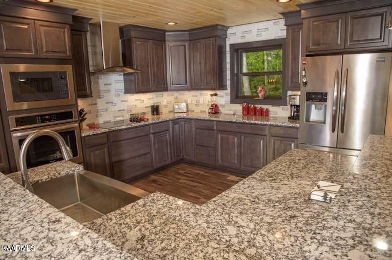 2252 Coopers Hawk Way Sevierville, TN 37862 - Photo 21 of 56 a kitchen with a sink cabinets and stainless steel appliances