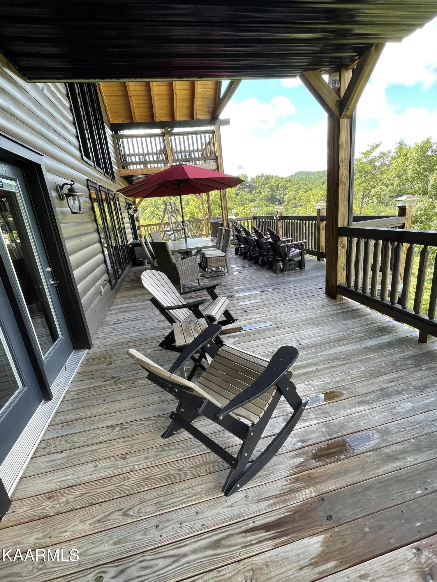 2252 Coopers Hawk Way Sevierville, TN 37862 - Photo 27 of 56 a view of a patio with a table chairs and wooden floor