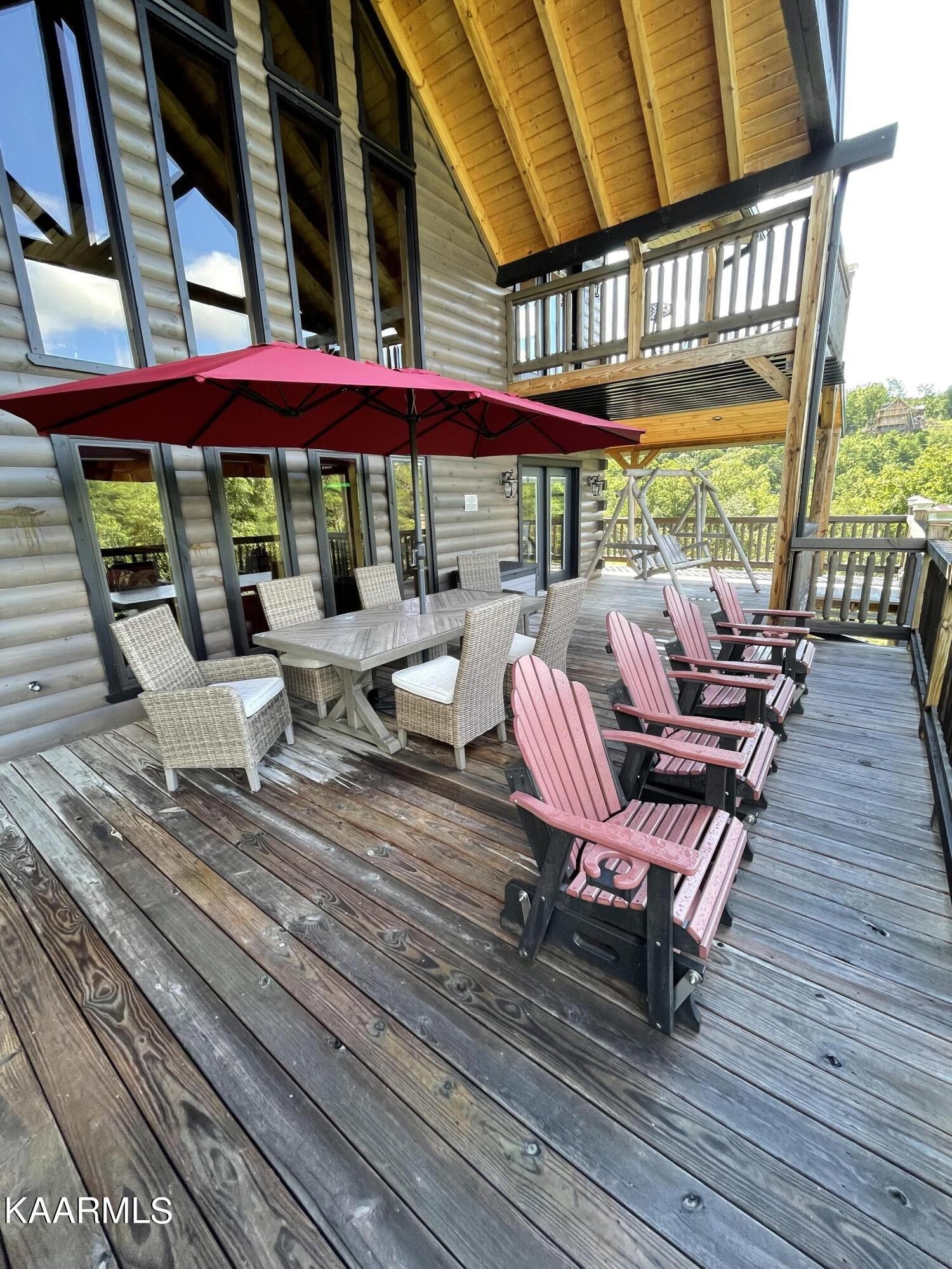 2252 Coopers Hawk Way Sevierville, TN 37862 - Photo 28 of 56 a view of a patio with lawn chairs under an umbrella