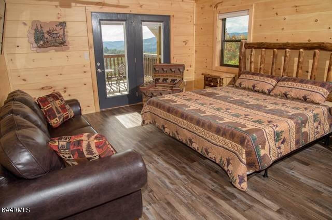 2252 Coopers Hawk Way Sevierville, TN 37862 - Photo 33 of 56 a large bed sitting in a bedroom next to a window with double vanity and a large window