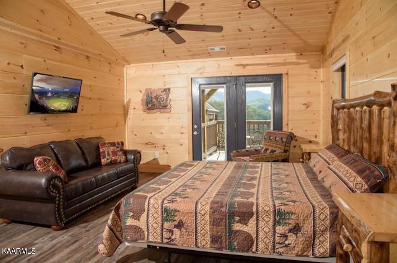 2252 Coopers Hawk Way Sevierville, TN 37862 - Photo 34 of 56 a view of a bedroom with a bed and wooden floor