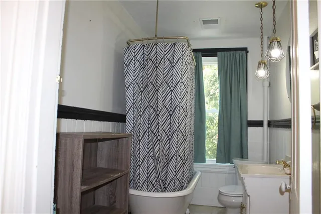 a bathroom with a toilet and a shower