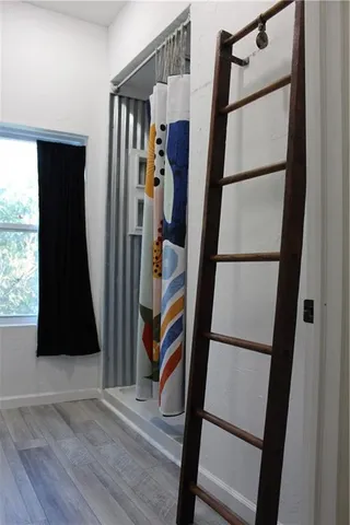 a view of an entryway with wooden floor and door