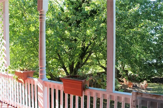 a view of a yard with iron fence