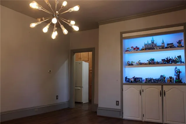 a view of a refrigerator in a kitchen and wooden floor