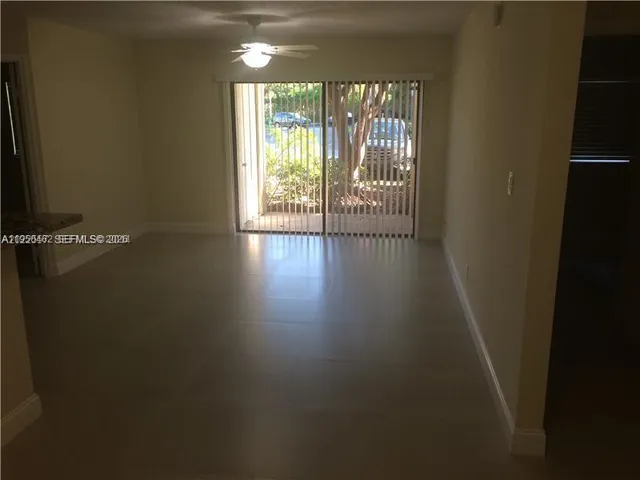 a view of a room with wooden floor and windows