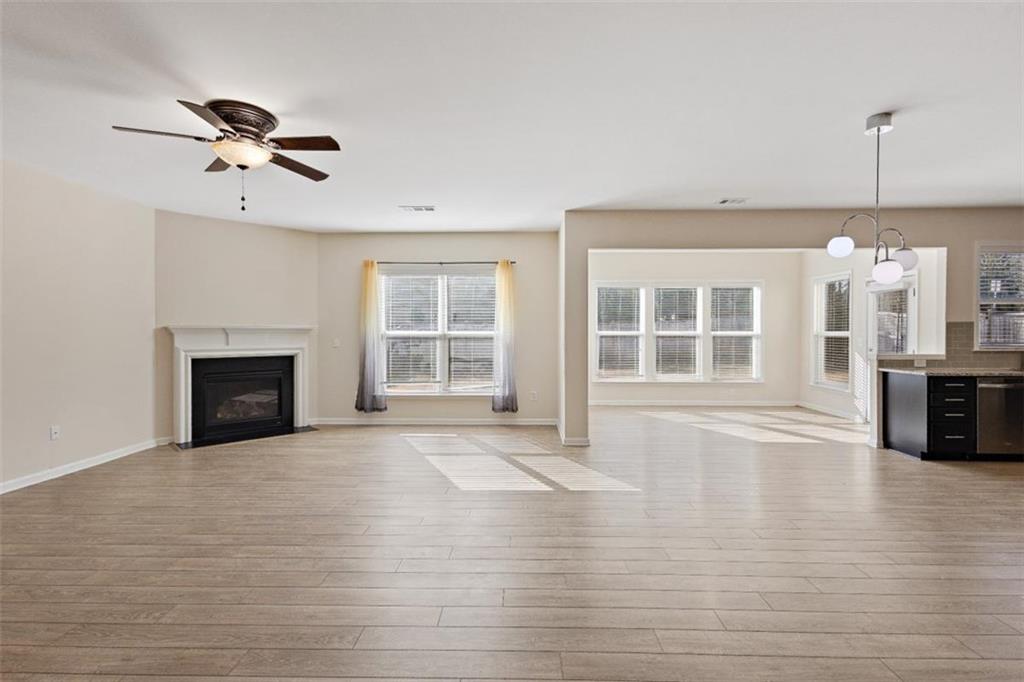 3500 Graham Way Southwest Lilburn, GA 30047 - Photo 11 of 47 a view of an empty room with a window and wooden floor