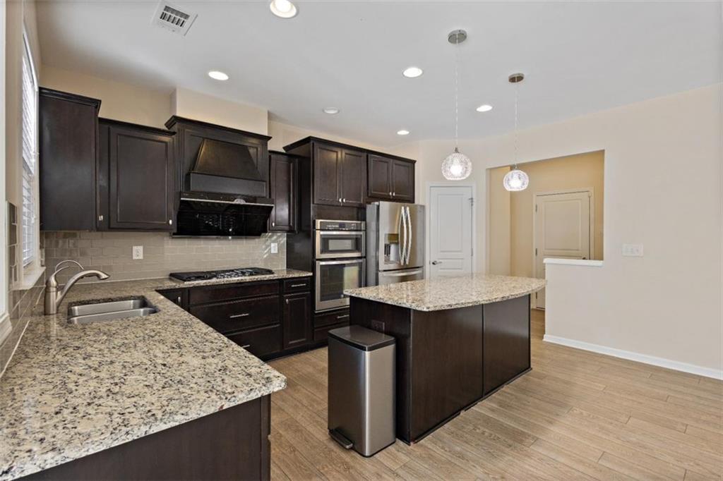 3500 Graham Way Southwest Lilburn, GA 30047 - Photo 12 of 47 a kitchen with stainless steel appliances granite countertop a sink stove and refrigerator