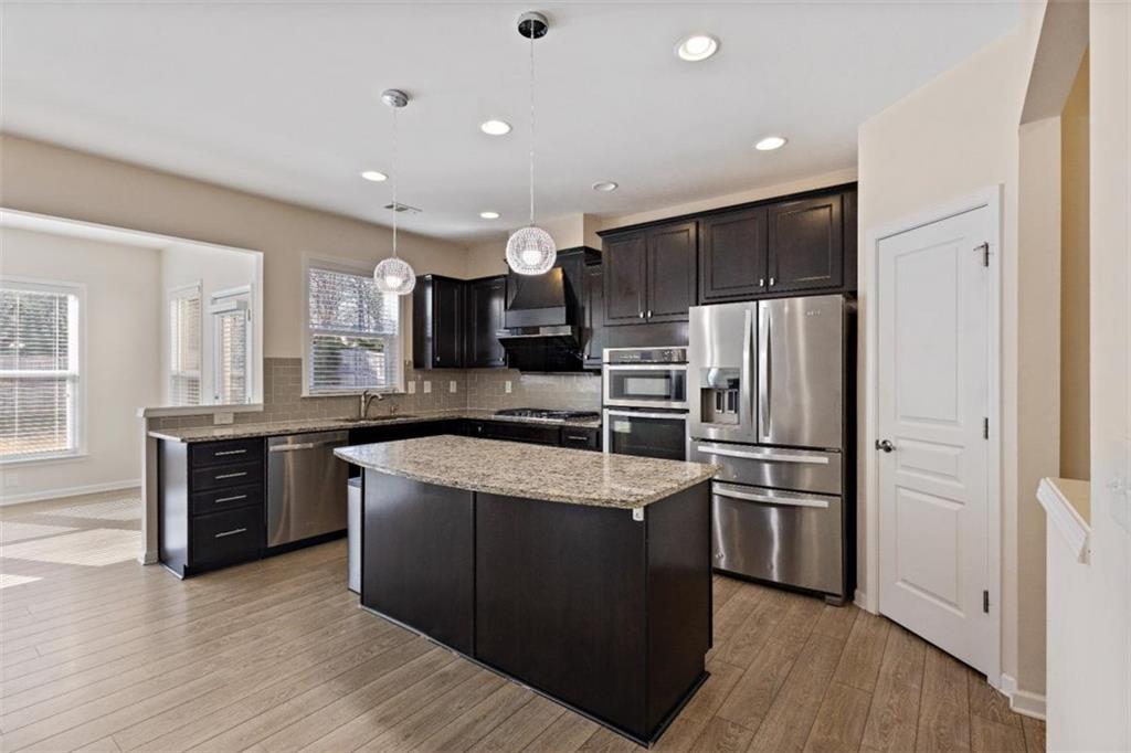 3500 Graham Way Southwest Lilburn, GA 30047 - Photo 13 of 47 a kitchen with stainless steel appliances granite countertop a refrigerator a sink a stove and oven