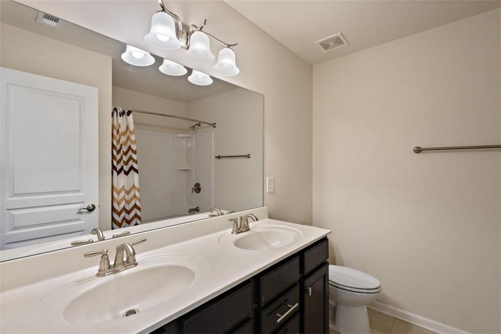 3500 Graham Way Southwest Lilburn, GA 30047 - Photo 23 of 47 a bathroom with a sink a toilet and a mirror