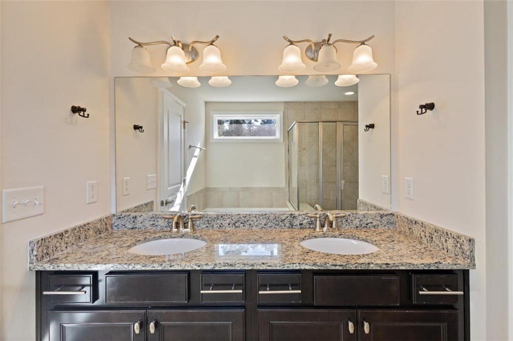 3500 Graham Way Southwest Lilburn, GA 30047 - Photo 37 of 47 a bathroom with a granite countertop double vanity and a mirror