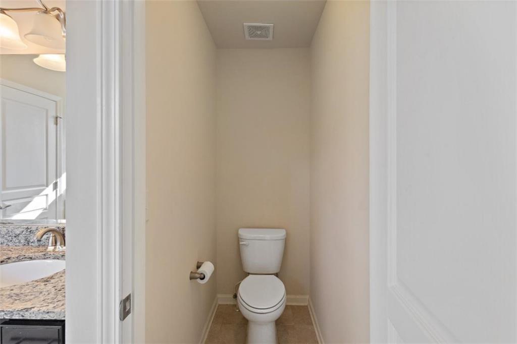 3500 Graham Way Southwest Lilburn, GA 30047 - Photo 40 of 47 a white toilet sitting next to a shower curtain