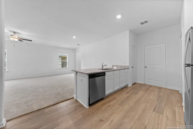 a kitchen with a sink and a stove top oven