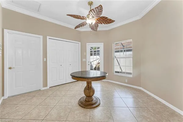 a living room with furniture a chandelier and a window