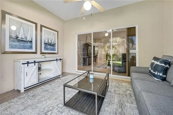 a living room with furniture a rug and wall painting