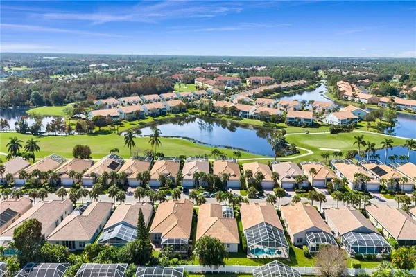 an aerial view of residential houses with outdoor space and river view