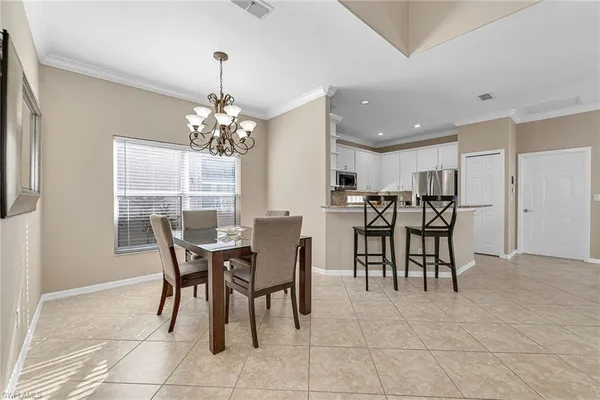 a view of a dining room with furniture and chandelier