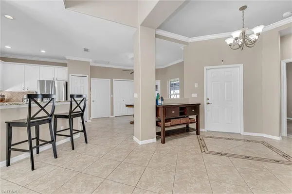 a view of a room with furniture and a chandelier