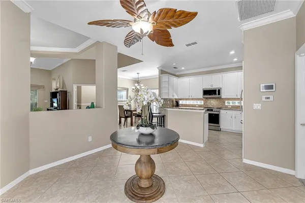 a kitchen with stainless steel appliances a dining table and chairs
