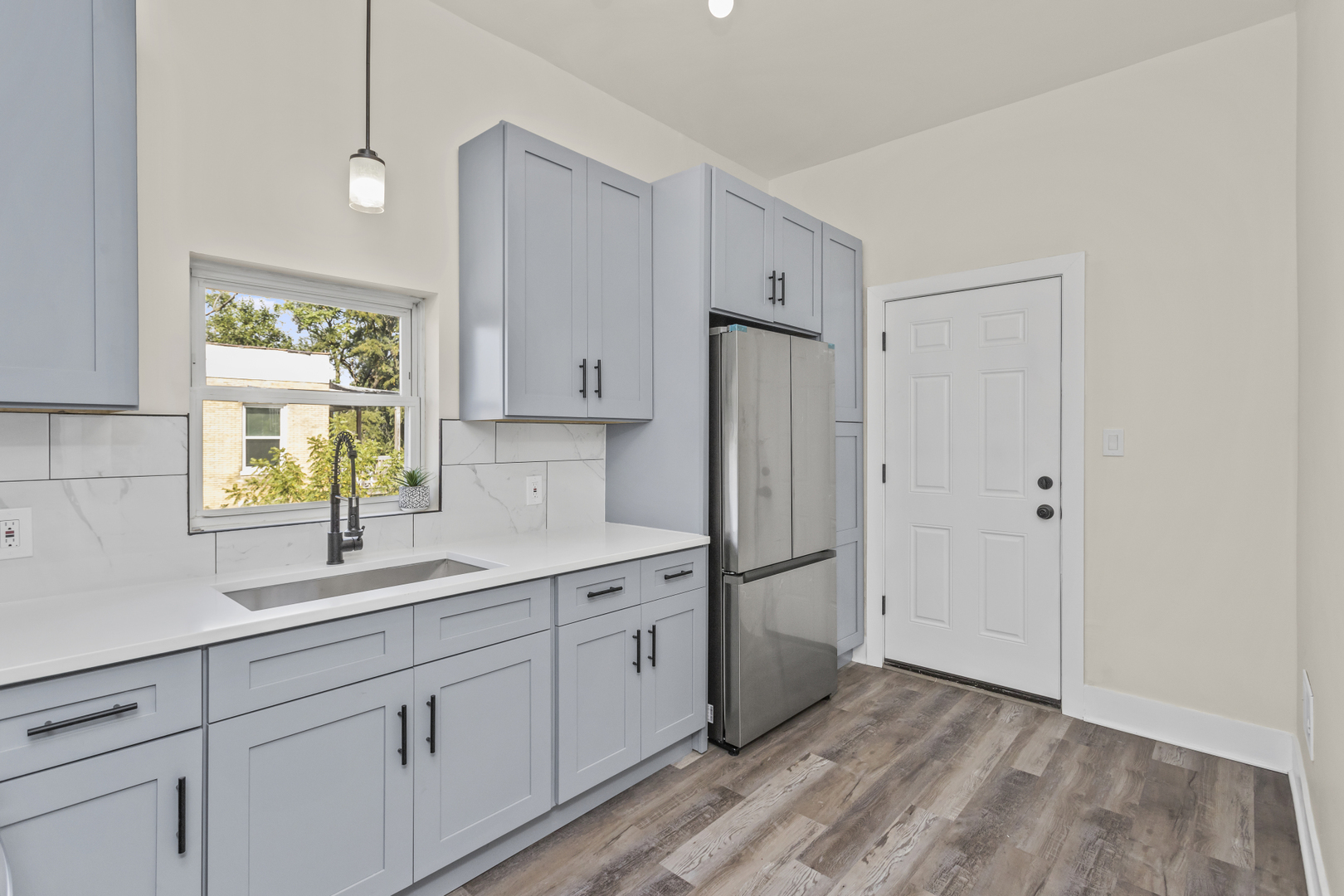 6601 South Rhodes Avenue Chicago, IL 60637 - Photo 11 of 22 a kitchen with white cabinets and window