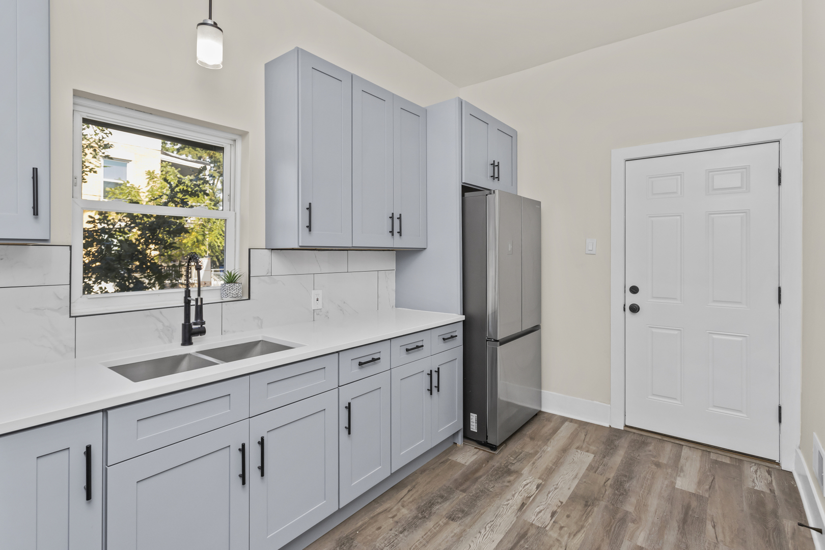 6601 South Rhodes Avenue Chicago, IL 60637 - Photo 21 of 22 a kitchen with a sink cabinets stainless steel appliances and a window