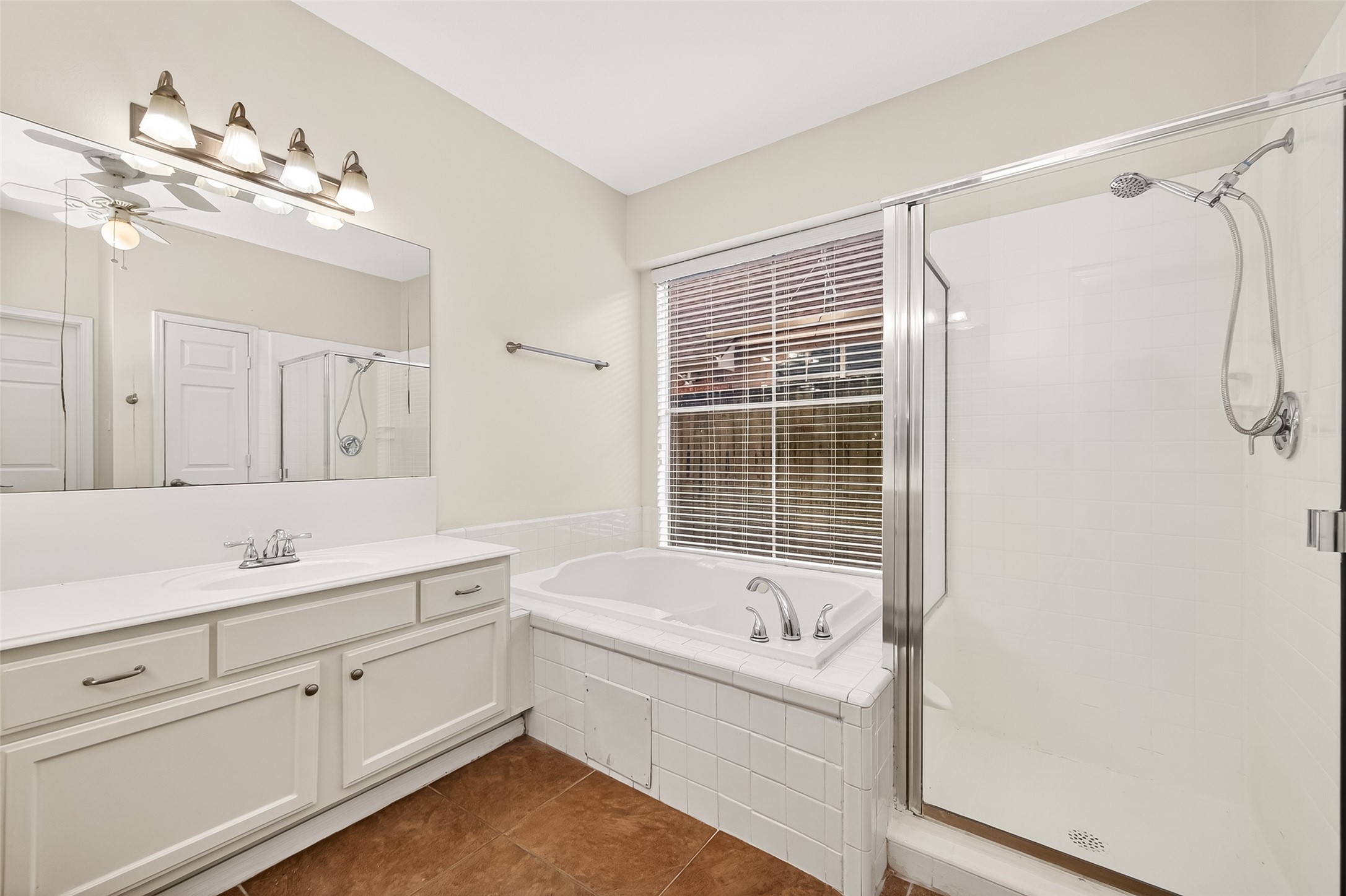 12831 Dove Point Lane Houston, TX 77041 - Photo 40 of 50 a bathroom with a tub sink and mirror