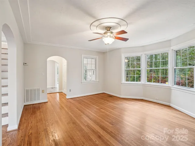 wooden floor in a room next to a window