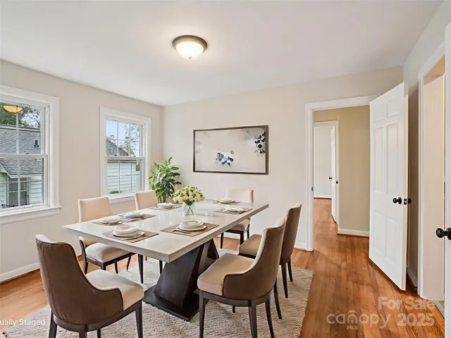 a view of a dining room with furniture and wooden floor