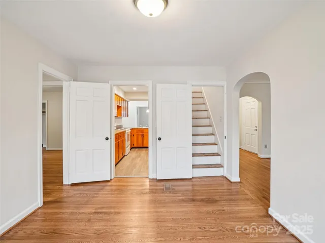 a view of a room with stairs and a wooden floor