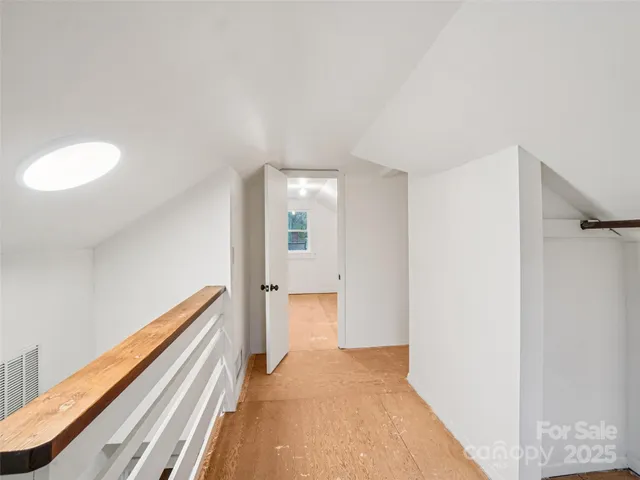 a view of a room with wooden floor and staircase