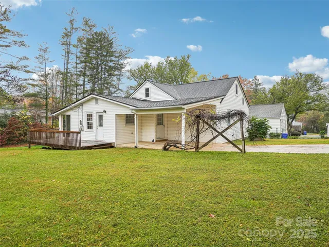 a view of a house with a yard and sitting area