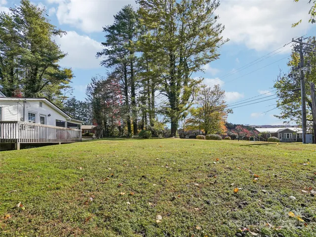 a house with green field in front of it