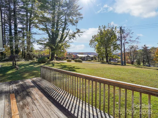 a view of deck with yard and trees