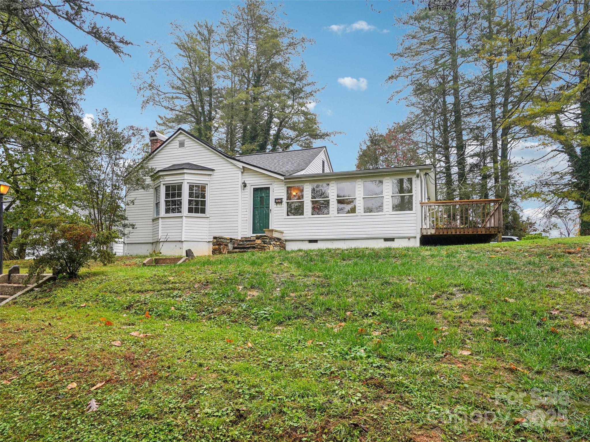34 Parkview Drive Brevard, NC 28712 - Photo 37 of 38 a front view of a house with a garden and trees