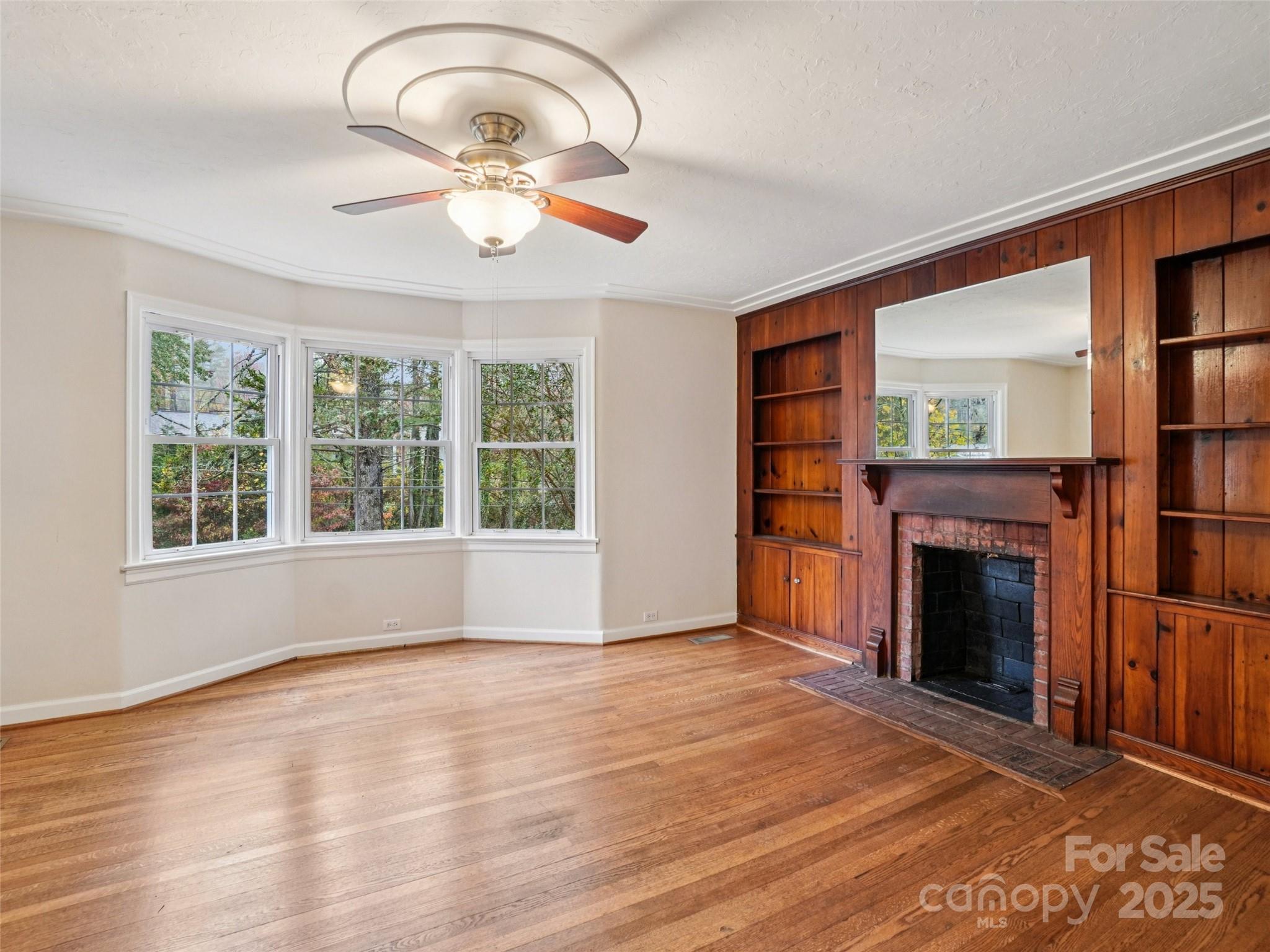34 Parkview Drive Brevard, NC 28712 - Photo 4 of 38 a view of an empty room with wooden floor fireplace and a window