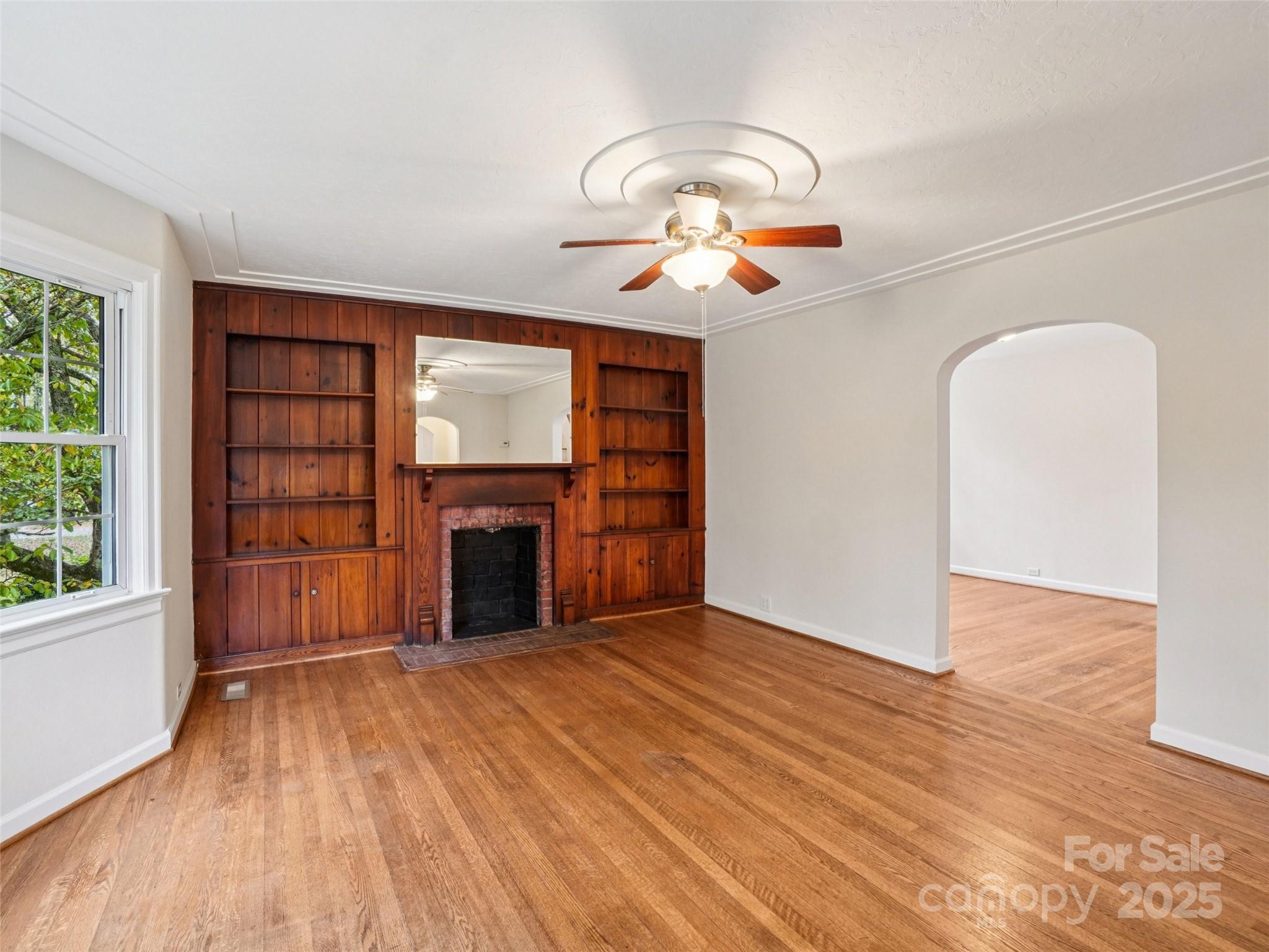 34 Parkview Drive Brevard, NC 28712 - Photo 6 of 38 an empty room with windows fireplace and wooden floor